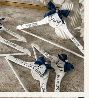 Personalised bridal party hangers with names, roles and the wedding date